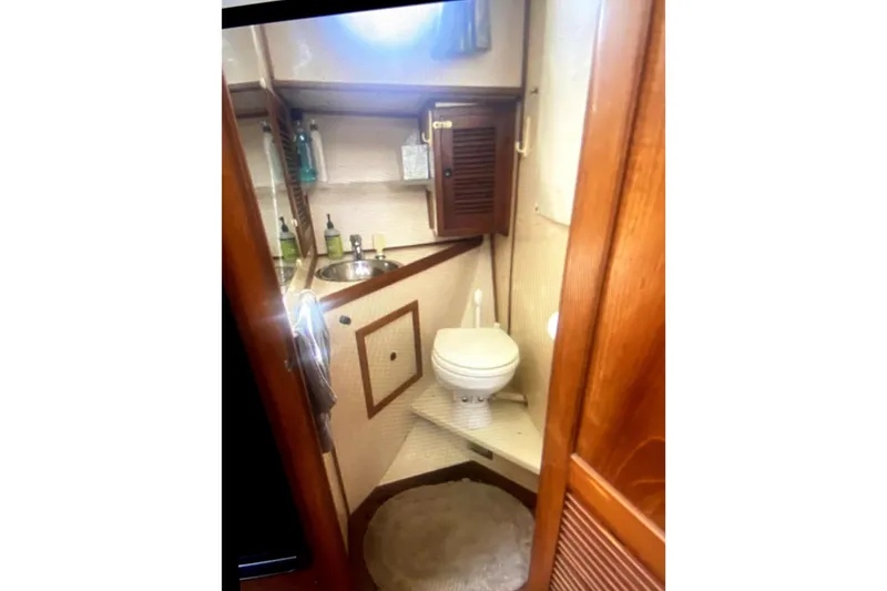 Slide: The Image of 1987 Senator-Chien Hwa Futura Sundeck bathroom with sink, toilet, and wooden cabinetry. - 25