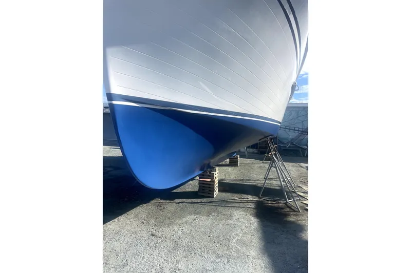 Slide: The Image of 1987 Senator-Chien Hwa Futura Sundeck boat hull on dry dock, blue and white finish. - 26