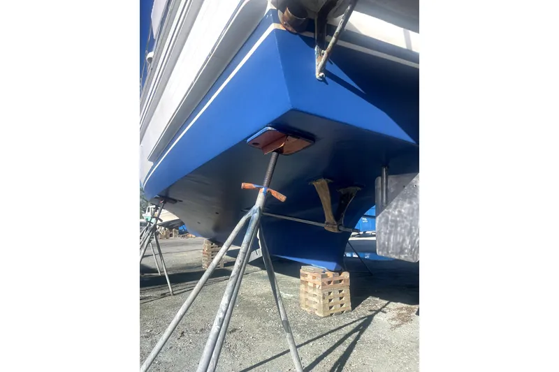 Slide: The Image of 1987 Senator-Chien Hwa Futura Sundeck boat on stands, blue hull, outdoor setting. - 27