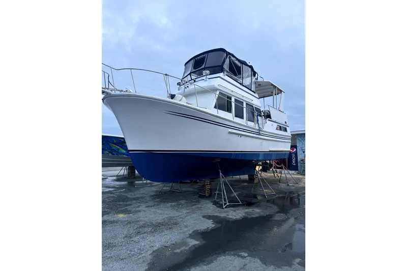 Slide: The Image of 1987 Senator-Chien Hwa Futura Sundeck boat on stands, white and blue hull. - 28