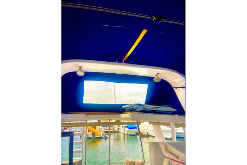 Slide: The Image of Interior view of 1987 Senator-Chien Hwa Futura sundeck with blue canopy and marina backdrop. - 4