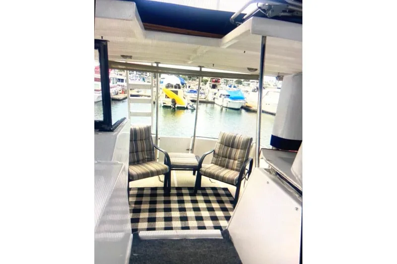 Slide: The Image of 1987 Senator-Chien Hwa Futura Sundeck interior with chairs and marina view. - 6