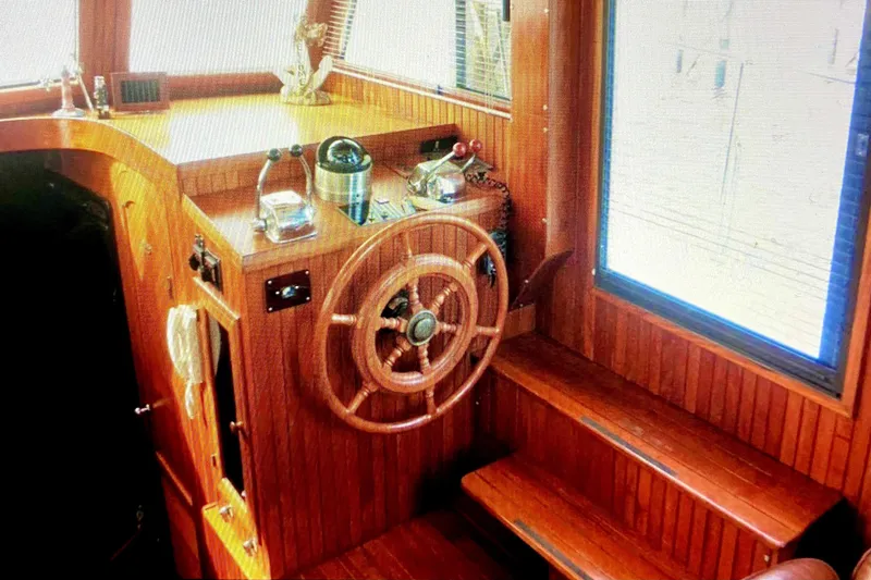 Slide: The Image of 1987 Senator-Chien Hwa Futura Sundeck boat interior with wooden helm and controls. - 8