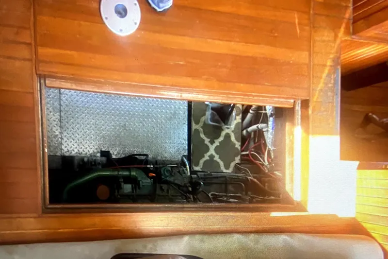 Slide: The Image of Engine compartment of a 1987 Senator-Chien Hwa Futura sundeck boat with wooden flooring. - 9