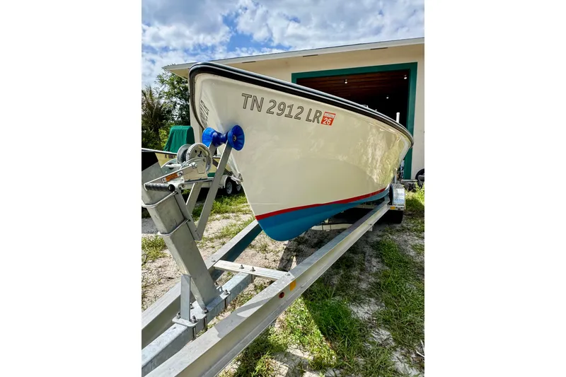Slide: The Image of 2025 Rambo 22 Center Console boat on trailer, parked outdoors. - 12