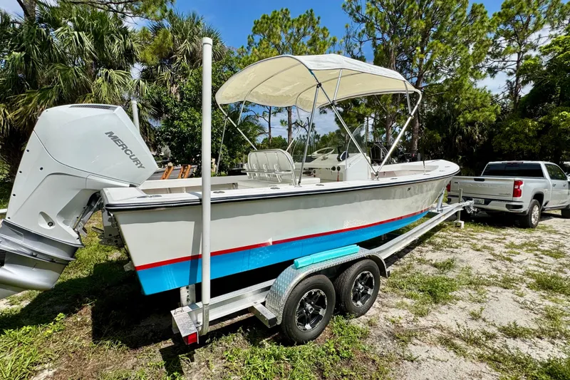 Slide: The Image of 2025 Rambo 22 Center Console boat on trailer, featuring Mercury outboard motor. - 14