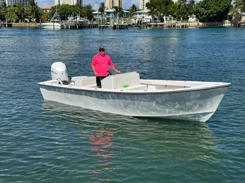 Slide: The Image of 2025 Rambo 22 Center Console boat on water with person in pink shirt. - 16