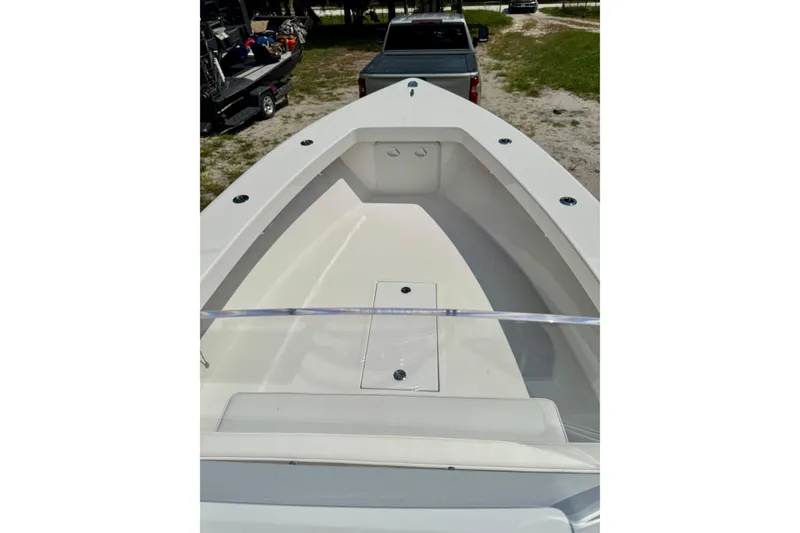 Slide: The Image of 2025 Rambo 22 Center Console boat, spacious deck view, parked outdoors. - 4