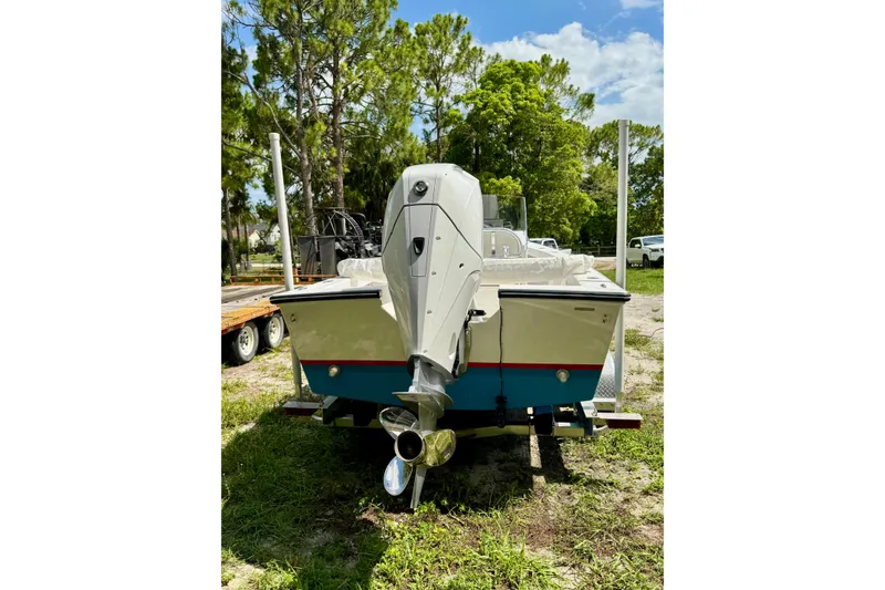 Slide: The Image of 2025 Rambo 22 Center Console boat with outboard motor, parked on grass. - 9