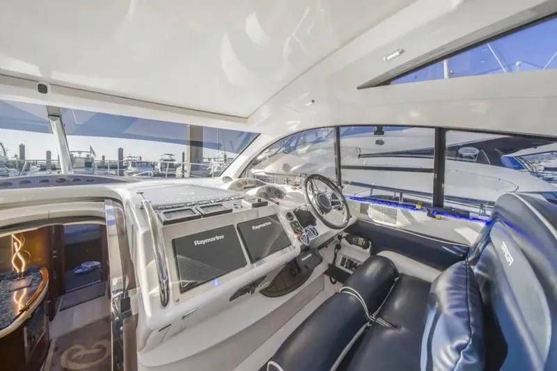 Slide: The Image of Interior of 2009 Fairline Targa 52 yacht, featuring modern navigation equipment and luxurious seating. - 10