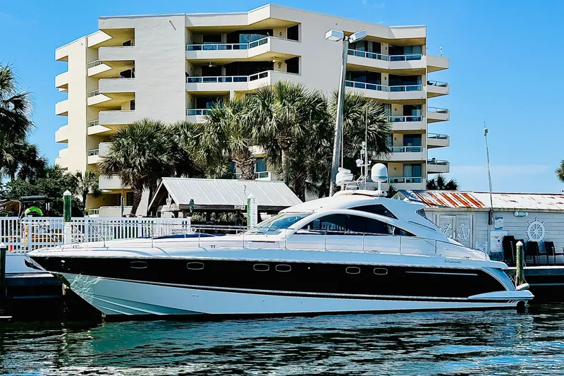 Slide: The Image of 2009 Fairline Targa 52 yacht docked near modern waterfront building. - 2