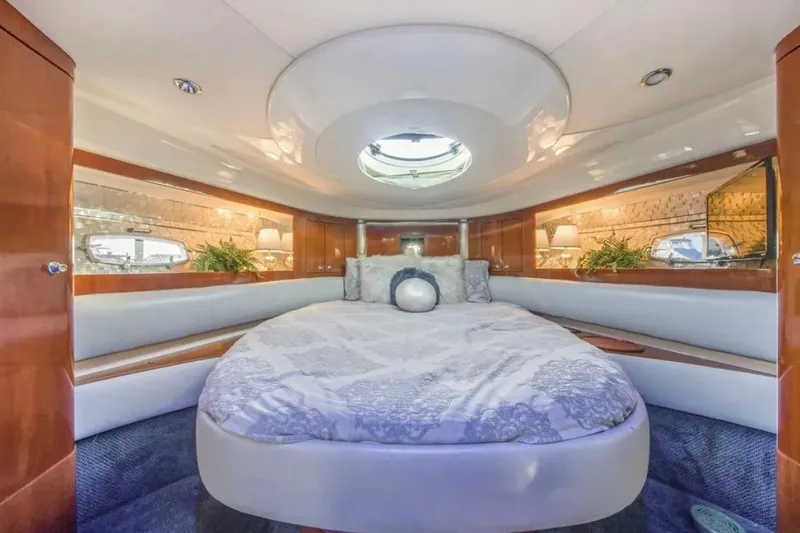 Slide: The Image of Luxurious interior of 2009 Fairline Targa 52 yacht with elegant bedding and wood accents. - 20