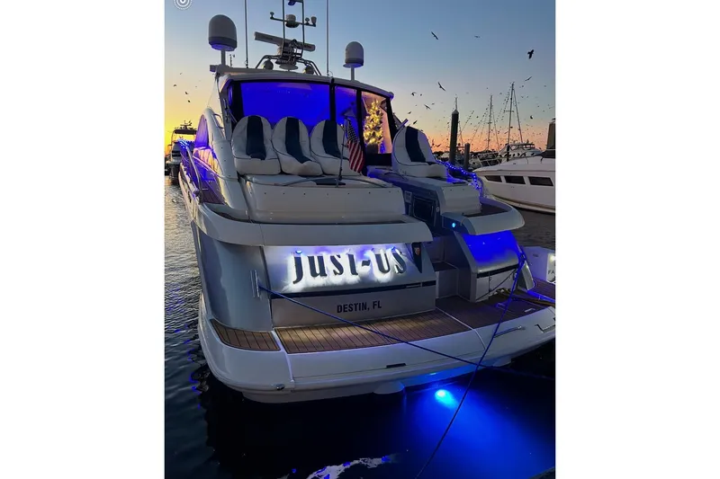 Slide: The Image of 2009 Fairline Targa 52 yacht at sunset, illuminated with blue lights, docked in Destin, FL. - 5
