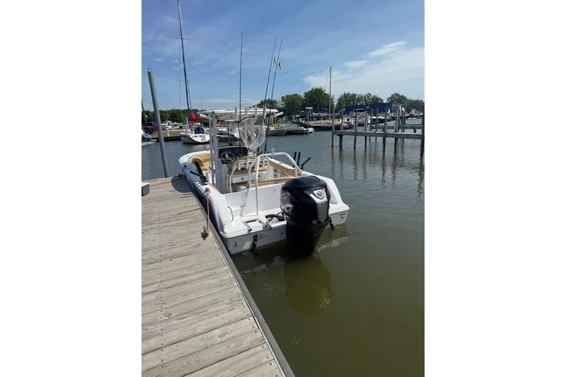 Slide: The Image of 2023 Sportsman Open 232 Center Console boat docked at marina. - 23