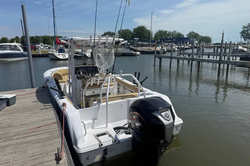 Slide: The Image of 2023 Sportsman Open 232 Center Console boat docked at a marina. - 24