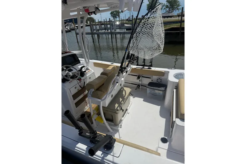 Slide: The Image of 2023 Sportsman Open 232 Center Console boat interior with fishing gear and seating. - 26