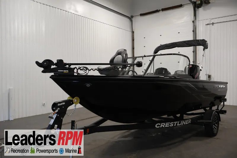 The Image of 2026 Crestliner 1850 Super Hawk WT JS boat in showroom, featuring sleek black design. - 3