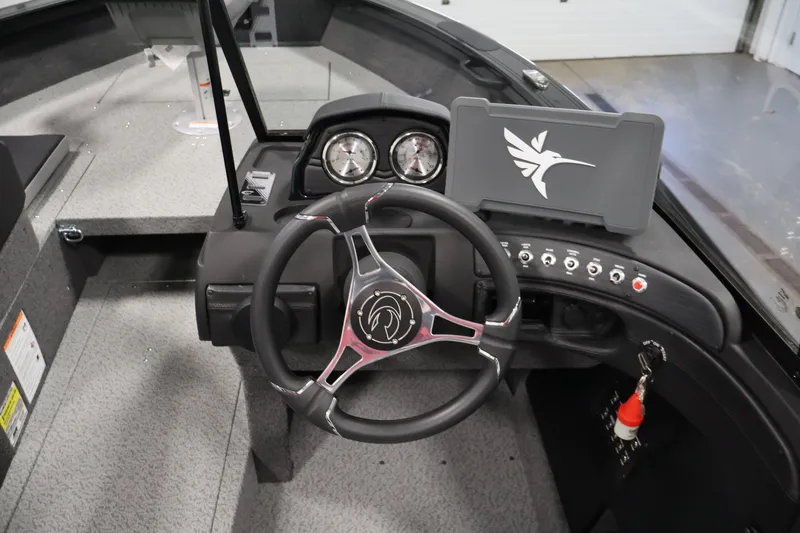 Slide: The Image of 2026 Crestliner 1850 Super Hawk WT JS boat dashboard with steering wheel and control panel. - 19