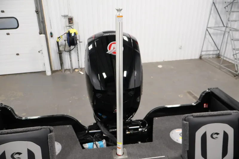 Slide: The Image of 2026 Crestliner 1850 Super Hawk WT JS boat interior with motor in a garage setting. - 36