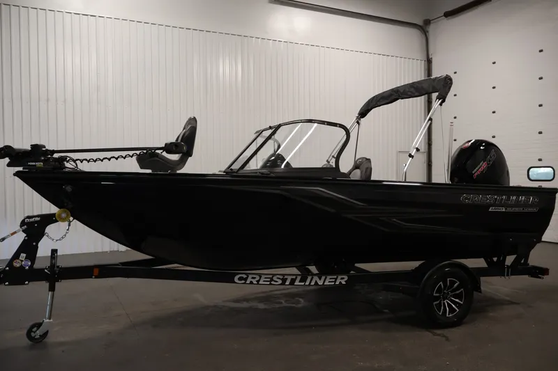 Slide: The Image of 2026 Crestliner 1850 Super Hawk WT JS boat in a showroom, side view. - 10
