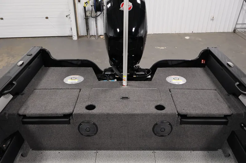 Slide: The Image of 2026 Crestliner 1850 Super Hawk WT JS boat interior with storage compartments and motor. - 31