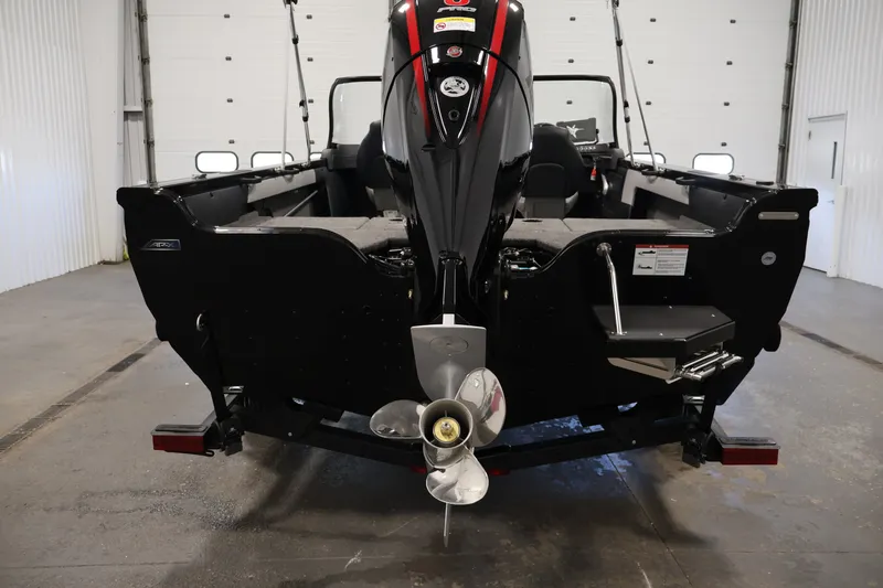 Slide: The Image of 2026 Crestliner 1850 Super Hawk WT JS boat, rear view in a garage setting. - 8