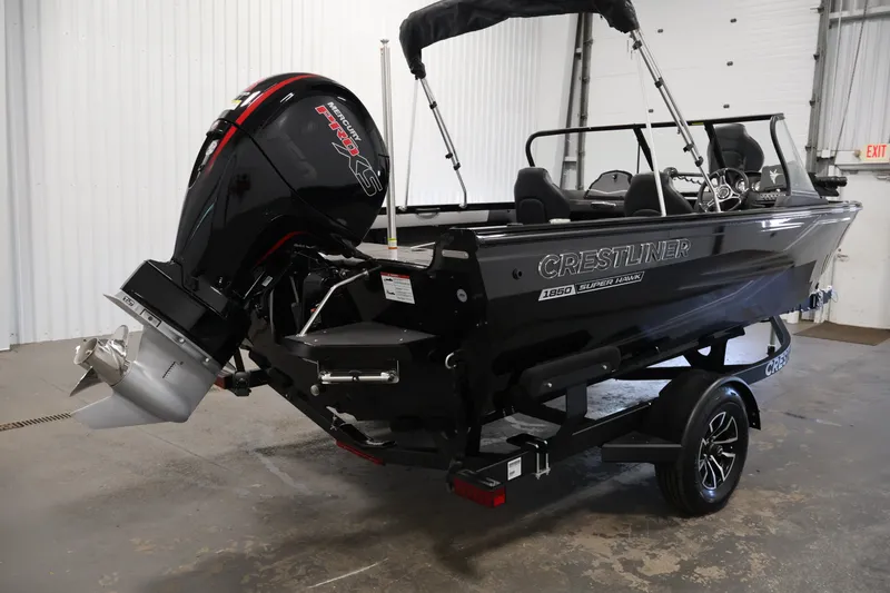 Slide: The Image of 2026 Crestliner 1850 Super Hawk WT JS boat with Mercury engine in a garage setting. - 7