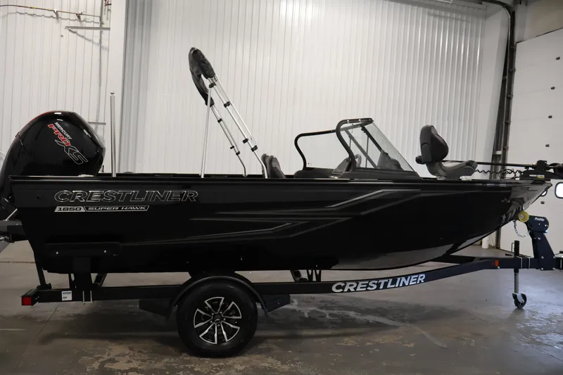 Slide: The Image of 2026 Crestliner 1850 Super Hawk WT JS boat in a showroom, side view. - 6