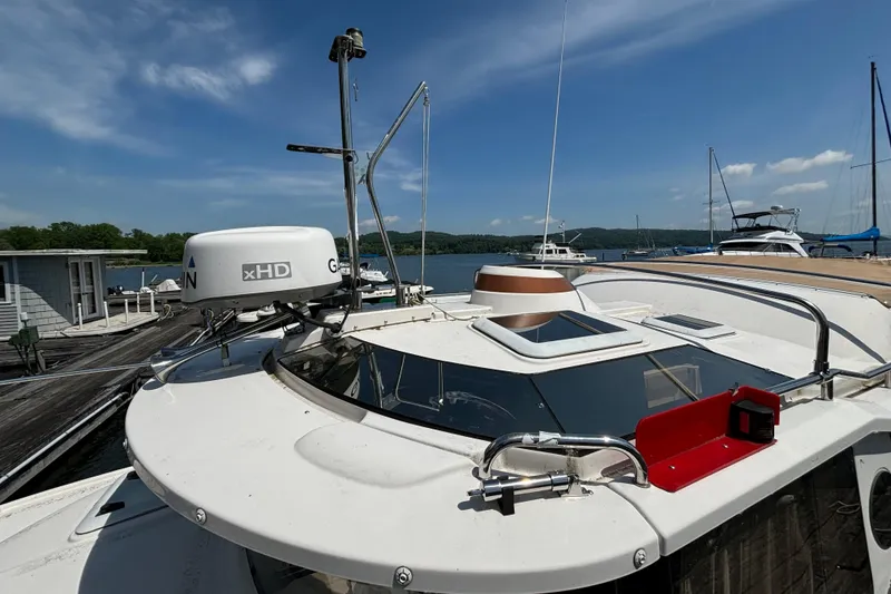 Slide: The Image of 2021 Ranger Tugs R-25 boat docked, featuring radar equipment and clear skies. - 10