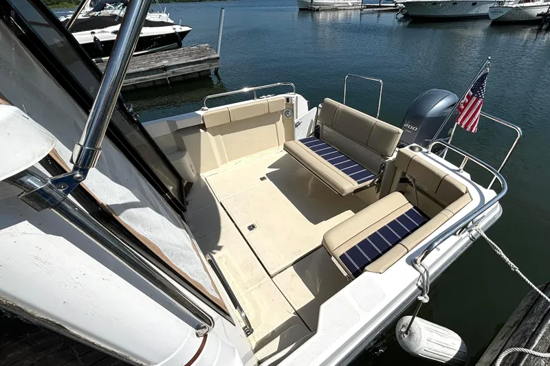 Slide: The Image of 2021 Ranger Tugs R-25 boat deck with seating, docked at marina. - 11