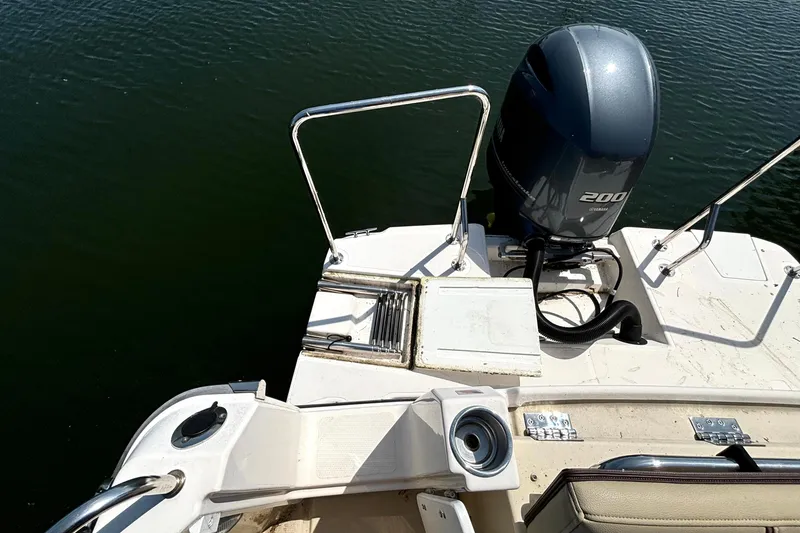 Slide: The Image of 2021 Ranger Tugs R-25 boat stern with Yamaha 200 engine on calm water. - 16