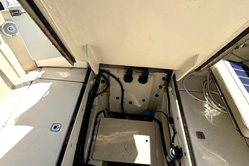 Slide: The Image of Engine compartment of a 2021 Ranger Tugs R-25 boat, showcasing internal components and wiring. - 22