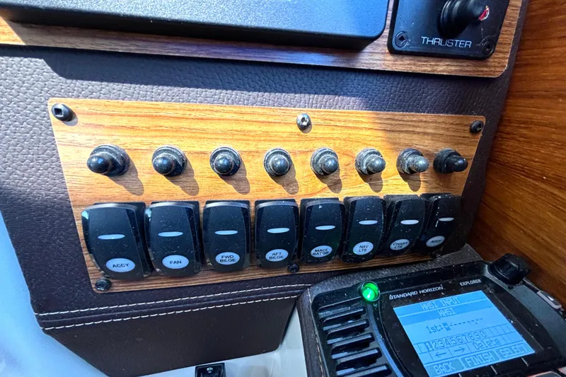 Slide: The Image of Control panel of a 2021 Ranger Tugs R-25 boat with switches and radio. - 36