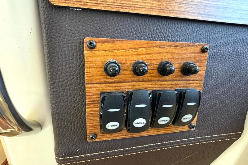 Slide: The Image of Control panel of a 2021 Ranger Tugs R-25 boat with labeled switches. - 37