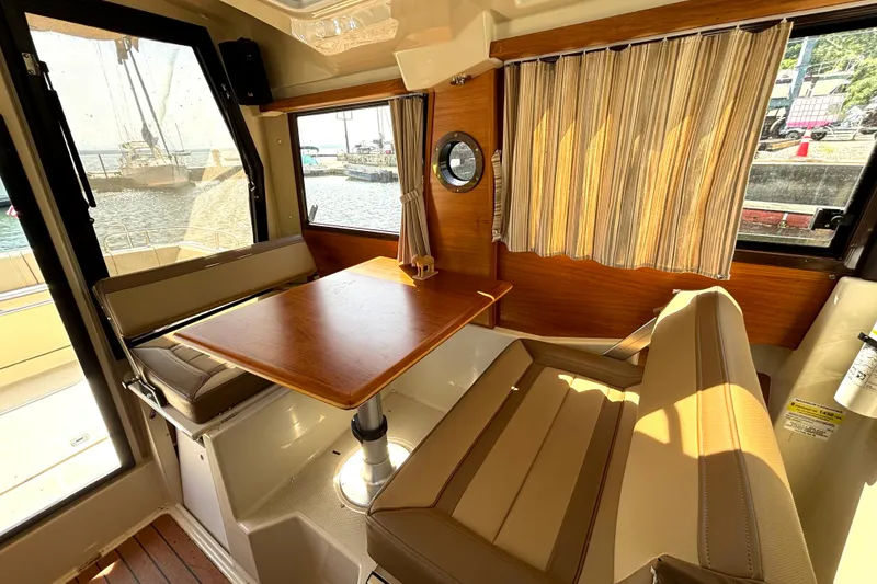 Slide: The Image of Interior of 2021 Ranger Tugs R-25 boat with dining area and window view. - 42