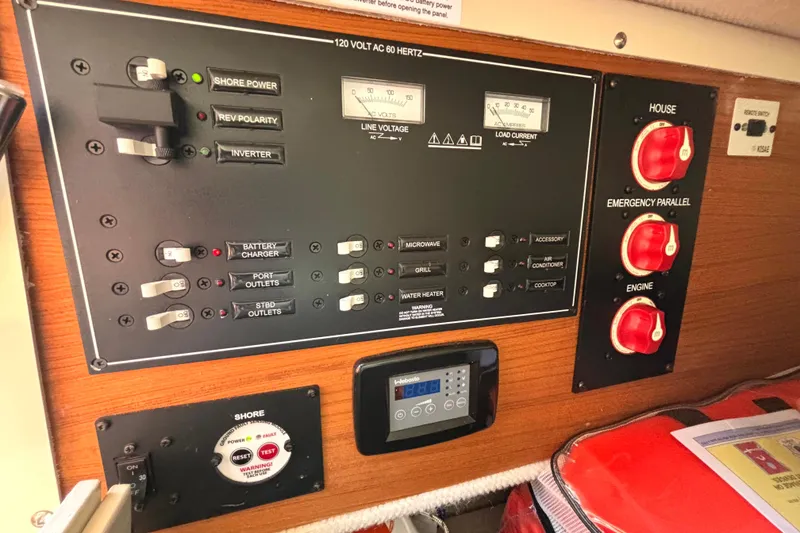 Slide: The Image of Electrical control panel of a 2021 Ranger Tugs R-25 boat, featuring switches and gauges. - 54