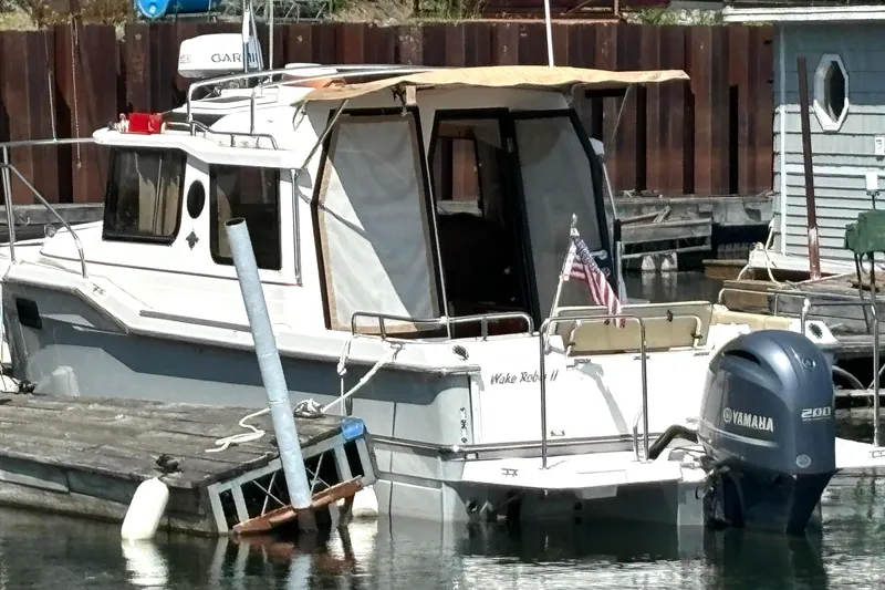 Slide: The Image of 2021 Ranger Tugs R-25 boat docked with Yamaha outboard motor. - 8