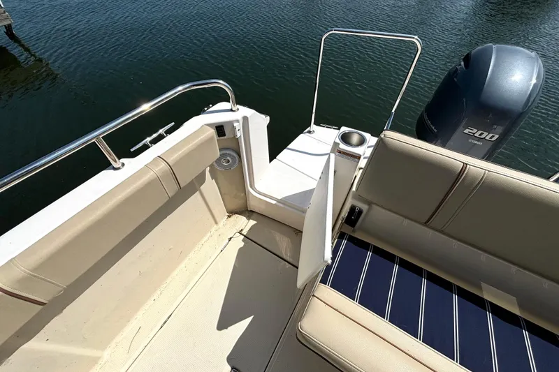 Slide: The Image of 2021 Ranger Tugs R-25 boat interior with seating and Yamaha 200 engine. - 15