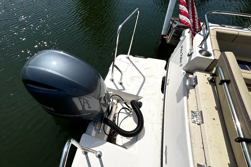 Slide: The Image of 2021 Ranger Tugs R-25 boat with Yamaha outboard motor and American flag on water. - 17