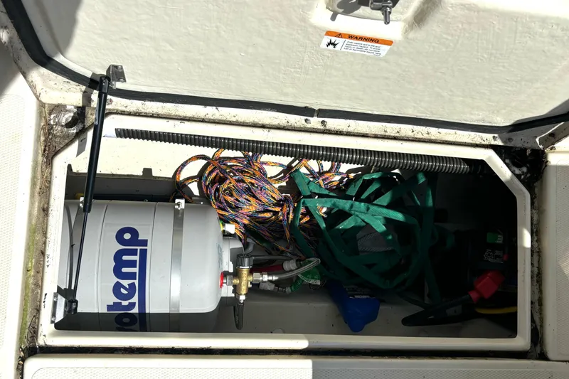 Slide: The Image of Storage compartment of a 2021 Ranger Tugs R-25 boat with equipment and wiring. - 21