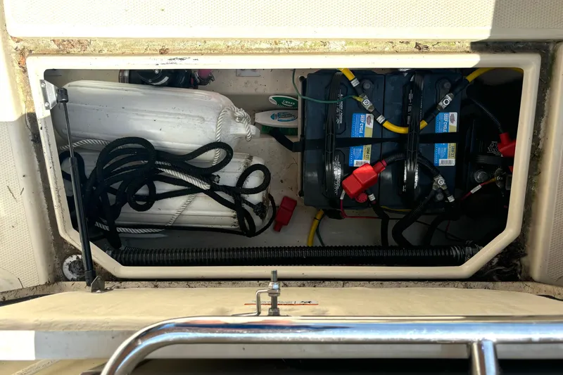 Slide: The Image of Storage compartment of 2021 Ranger Tugs R-25 with batteries and ropes. - 23