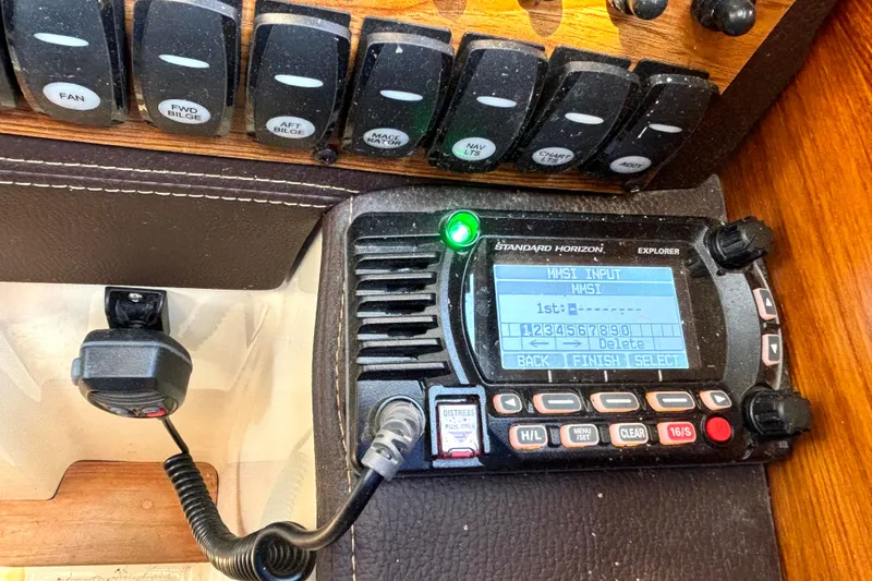 Slide: The Image of Standard Horizon radio on 2021 Ranger Tugs R-25 boat dashboard with control switches. - 35