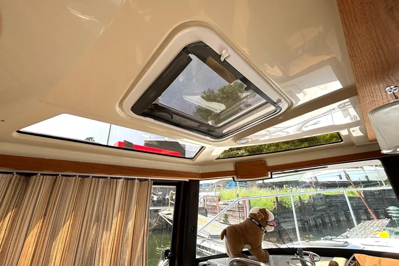 Slide: The Image of Interior view of 2021 Ranger Tugs R-25 boat with sunroof and plush toy. - 46