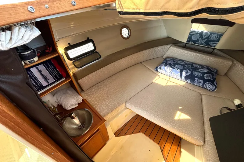 Slide: The Image of Cozy interior cabin of 2021 Ranger Tugs R-25 with bed, sink, and storage shelves. - 49