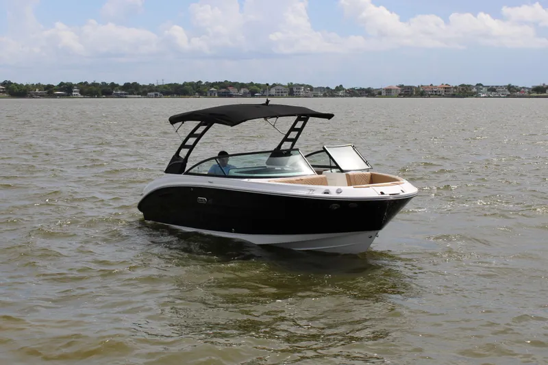 Slide: The Image of A sleek motorboat with a black hull and sunshade cruising on calm waters. - 5