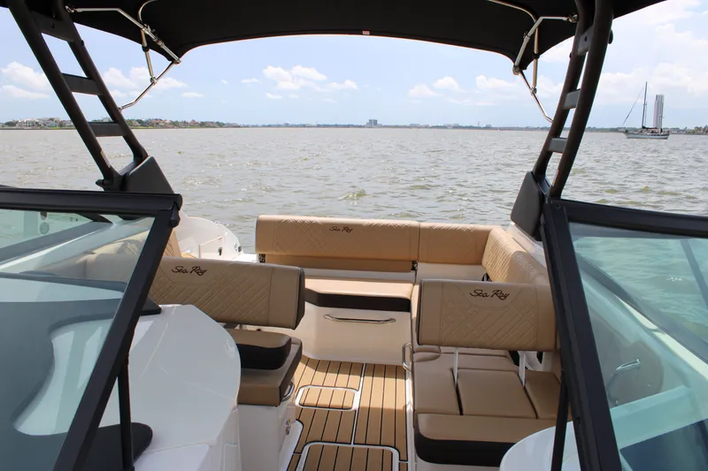 Slide: The Image of The image shows the interior of a 2026 Sea Ray SDX 250 Surf boat with beige seating. - 23