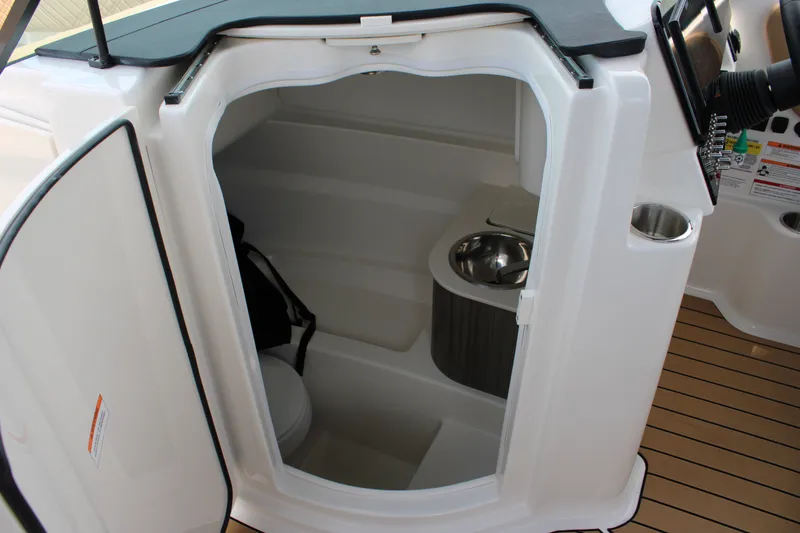 Slide: The Image of Interior view of a 2026 Sea Ray SDX 250 Surf featuring a toilet and sink. - 16