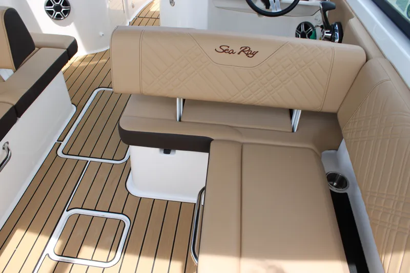 Slide: The Image of Interior of a Sea Ray SDX 250 Surf with beige upholstery and wood flooring. - 9