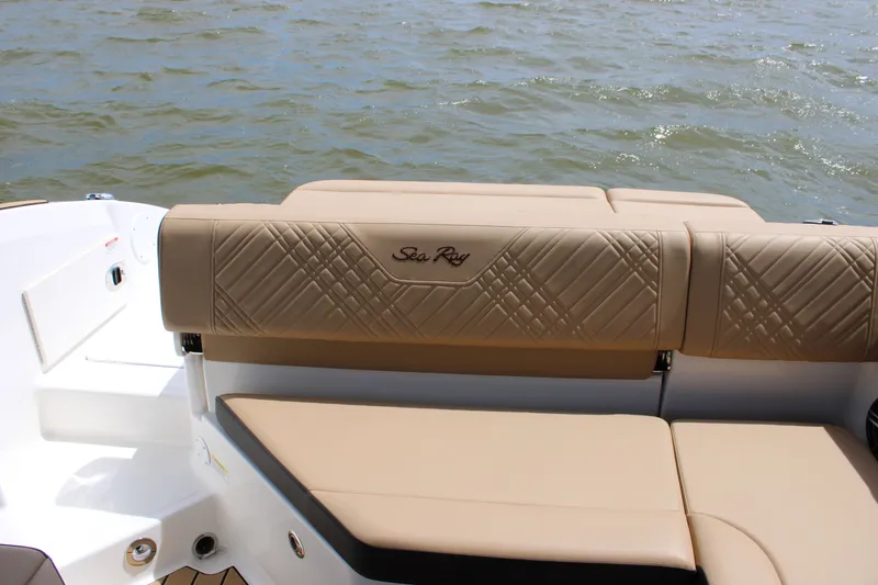 Slide: The Image of The image shows the stern of a Sea Ray SDX 250 Surf boat with beige upholstery. - 38