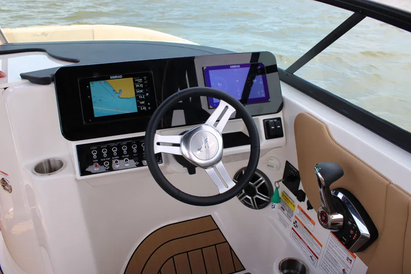 Slide: The Image of The image shows the helm of a 2026 Sea Ray SDX 250 Surf with modern instruments. - 32